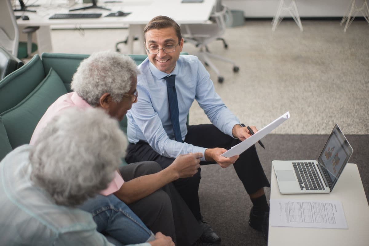 A financial advisor reviewing documents with senior clients
