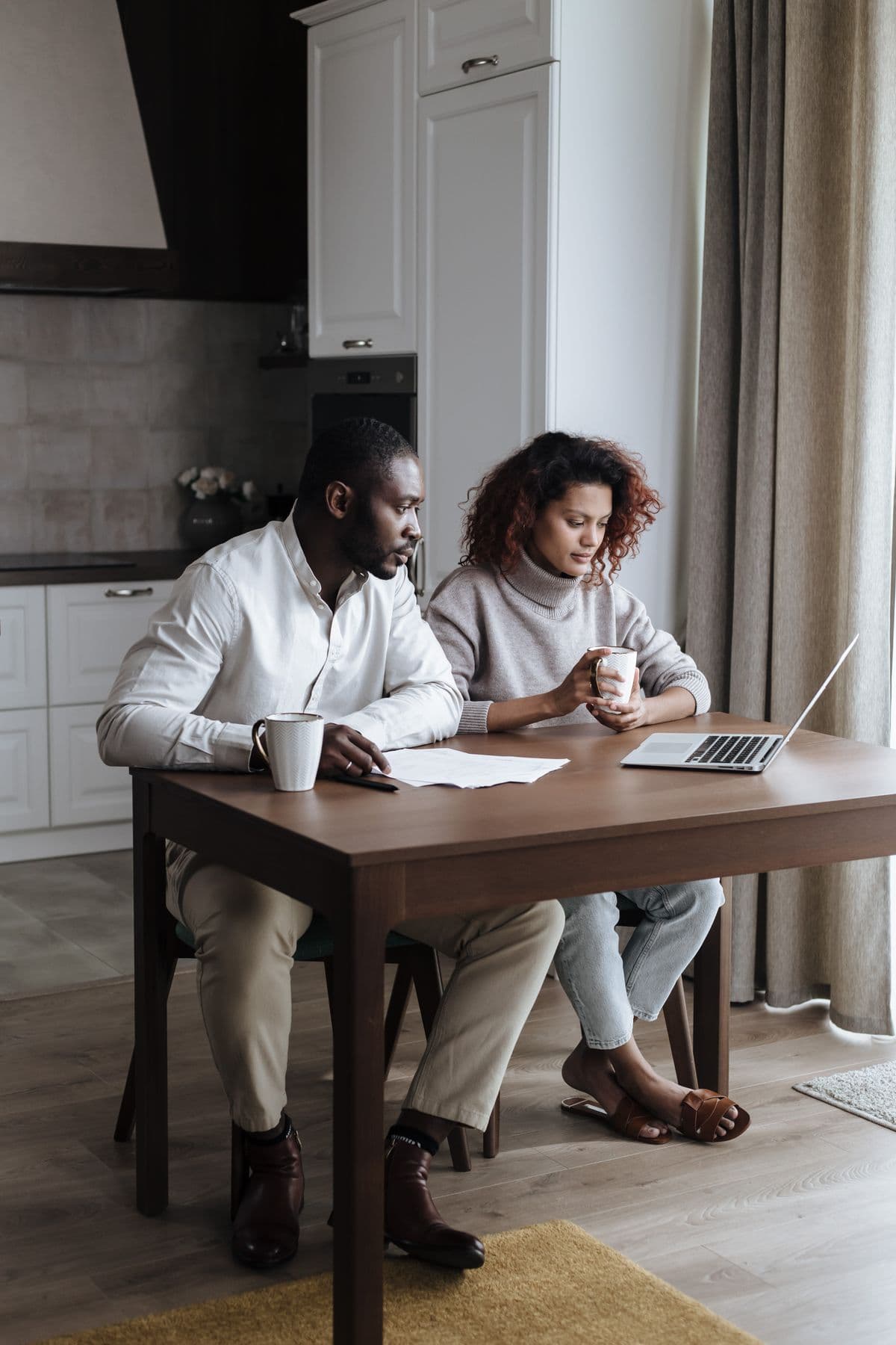 A couple reviewing important documents together at home